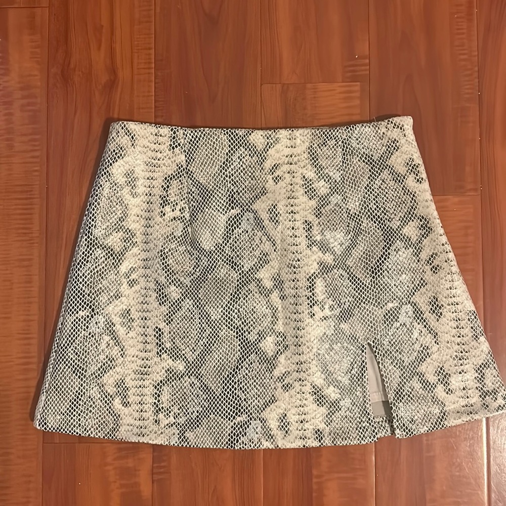 Olivaceous mini snakeskin skirt with slit on the side